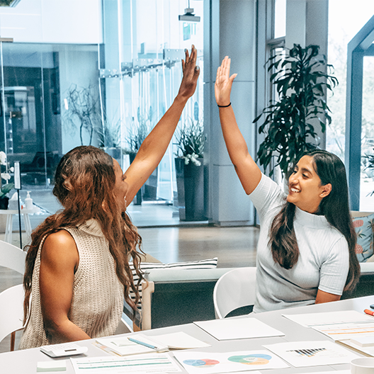 Two womens doing hi five